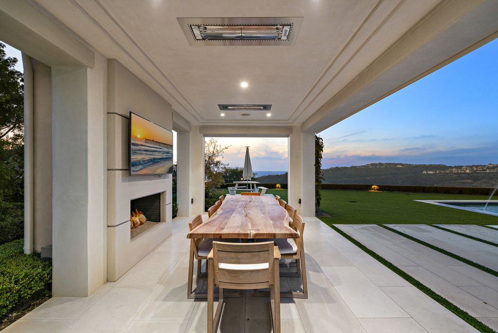 21 Spinnaker Home in Newport Coast, California. Discover luxury living at its finest in this stunning 11,700 sq. ft. estate in Crystal Cove. Completed in 2020, this meticulously designed residence offers unobstructed ocean and coastline views, dual master suites, a chef's kitchen, home theater, gym, and more. 