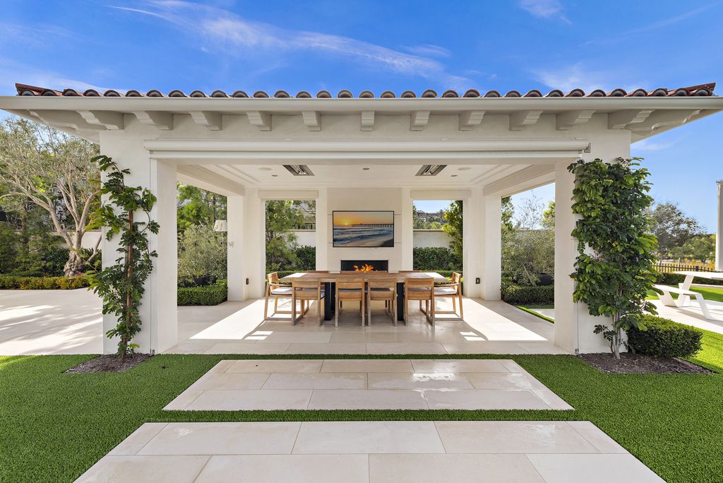21 Spinnaker Home in Newport Coast, California. Discover luxury living at its finest in this stunning 11,700 sq. ft. estate in Crystal Cove. Completed in 2020, this meticulously designed residence offers unobstructed ocean and coastline views, dual master suites, a chef's kitchen, home theater, gym, and more. 