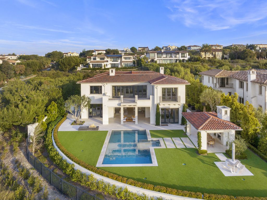 21 Spinnaker Home in Newport Coast, California. Discover luxury living at its finest in this stunning 11,700 sq. ft. estate in Crystal Cove. Completed in 2020, this meticulously designed residence offers unobstructed ocean and coastline views, dual master suites, a chef's kitchen, home theater, gym, and more. 