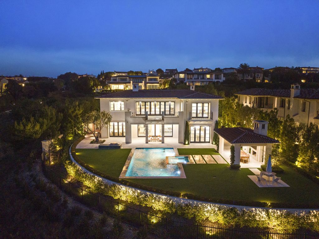 21 Spinnaker Home in Newport Coast, California. Discover luxury living at its finest in this stunning 11,700 sq. ft. estate in Crystal Cove. Completed in 2020, this meticulously designed residence offers unobstructed ocean and coastline views, dual master suites, a chef's kitchen, home theater, gym, and more. 