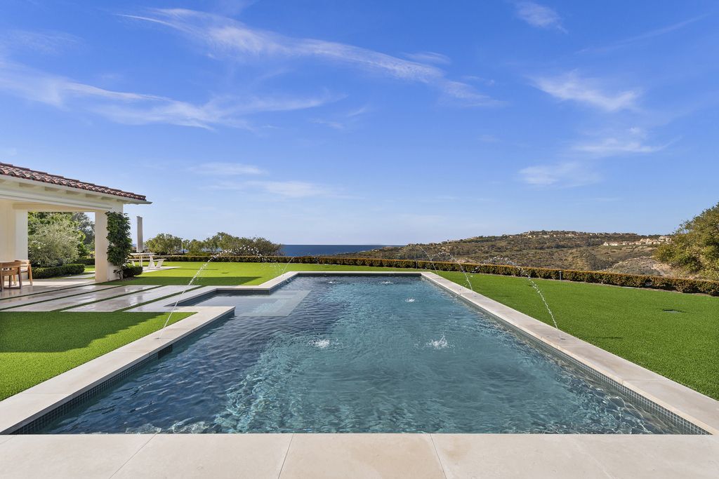 21 Spinnaker Home in Newport Coast, California. Discover luxury living at its finest in this stunning 11,700 sq. ft. estate in Crystal Cove. Completed in 2020, this meticulously designed residence offers unobstructed ocean and coastline views, dual master suites, a chef's kitchen, home theater, gym, and more. 