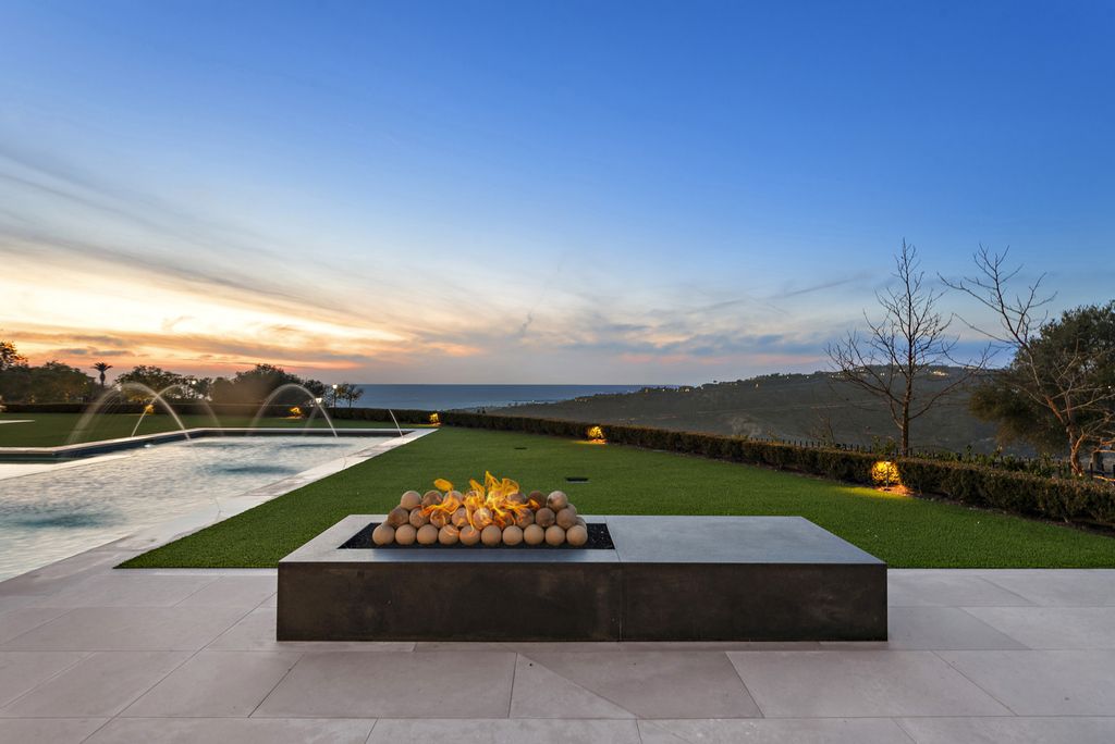 21 Spinnaker Home in Newport Coast, California. Discover luxury living at its finest in this stunning 11,700 sq. ft. estate in Crystal Cove. Completed in 2020, this meticulously designed residence offers unobstructed ocean and coastline views, dual master suites, a chef's kitchen, home theater, gym, and more. 