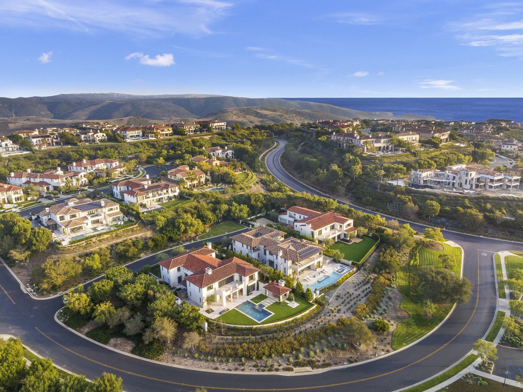 21 Spinnaker Home in Newport Coast, California. Discover luxury living at its finest in this stunning 11,700 sq. ft. estate in Crystal Cove. Completed in 2020, this meticulously designed residence offers unobstructed ocean and coastline views, dual master suites, a chef's kitchen, home theater, gym, and more. 