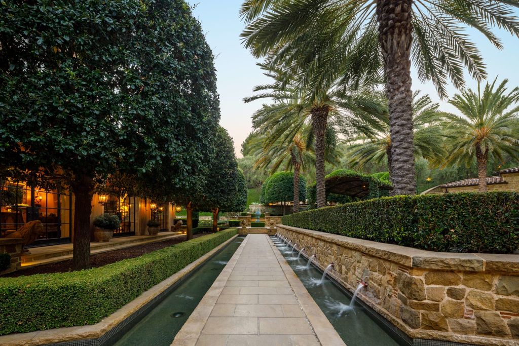 38 Beverly Park Circle Home in Beverly Hills, California. Explore the enchanting Tuscan Villa in the prestigious guard-gated enclave of Beverly Park. This Robert Sinclair masterpiece offers 5 bedrooms, 11 bathrooms, and a host of luxurious features. Nestled on nearly 3 acres, the property boasts mature trees, fountains, and serene walkways.