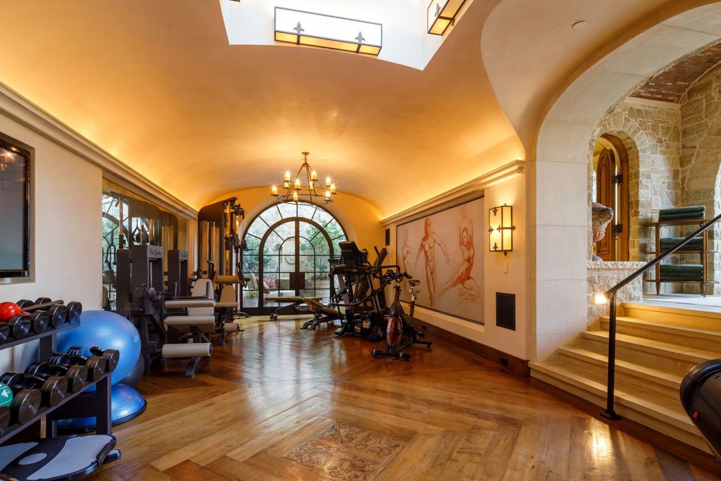 38 Beverly Park Circle Home in Beverly Hills, California. Explore the enchanting Tuscan Villa in the prestigious guard-gated enclave of Beverly Park. This Robert Sinclair masterpiece offers 5 bedrooms, 11 bathrooms, and a host of luxurious features. Nestled on nearly 3 acres, the property boasts mature trees, fountains, and serene walkways.