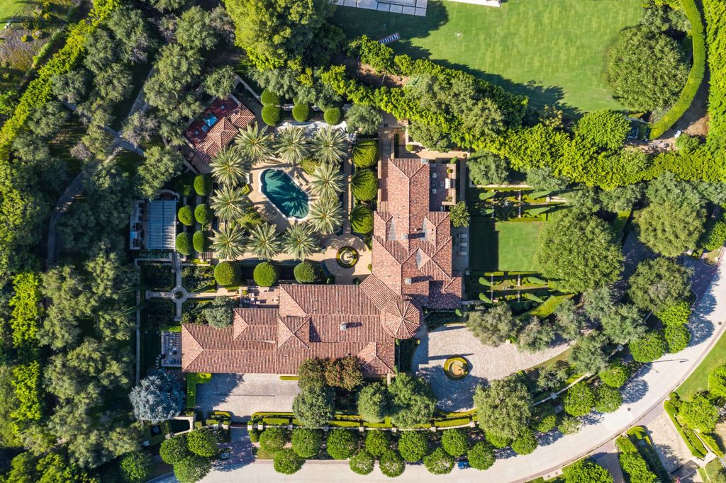 38 Beverly Park Circle Home in Beverly Hills, California. Explore the enchanting Tuscan Villa in the prestigious guard-gated enclave of Beverly Park. This Robert Sinclair masterpiece offers 5 bedrooms, 11 bathrooms, and a host of luxurious features. Nestled on nearly 3 acres, the property boasts mature trees, fountains, and serene walkways.