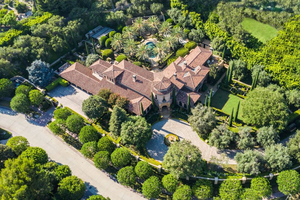 38 Beverly Park Circle Home in Beverly Hills, California. Explore the enchanting Tuscan Villa in the prestigious guard-gated enclave of Beverly Park. This Robert Sinclair masterpiece offers 5 bedrooms, 11 bathrooms, and a host of luxurious features. Nestled on nearly 3 acres, the property boasts mature trees, fountains, and serene walkways.
