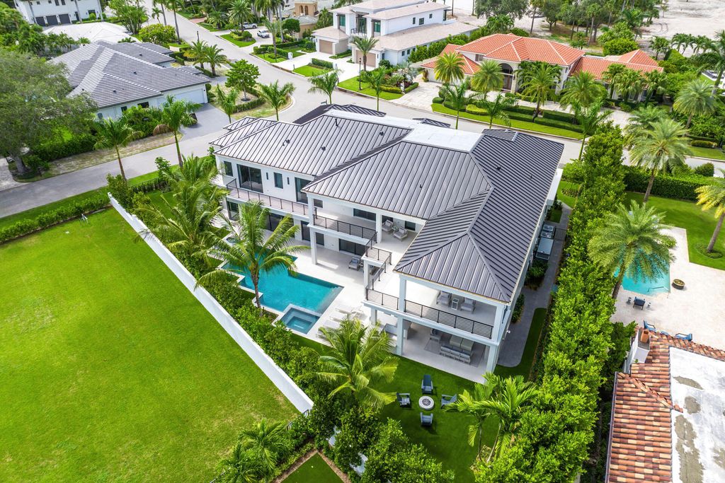 484 Royal Palm Way Home in Boca Raton, Florida. Discover the pinnacle of opulence in Boca Raton with this stunning Signature Estate by SRD Building Corp. Located in the prestigious Royal Palm Yacht & Country Club, this exquisite property offers six bedroom suites, 7 full and 2 half bathrooms, and unparalleled features like a Crestron smart-home system.