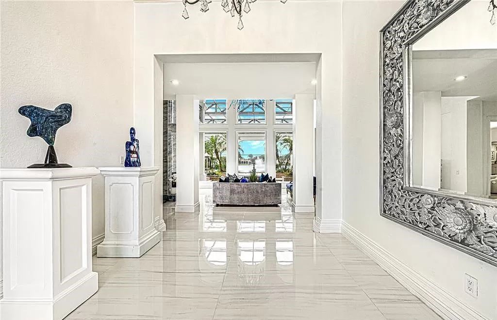 Welcome to Sunspray Estate, an exquisite 5-bedroom masterpiece nestled along the shores of a secluded spring-fed lake in Naples, Florida.