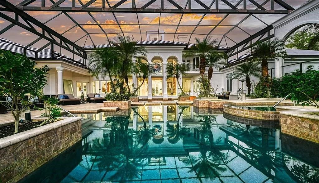 Welcome to Sunspray Estate, an exquisite 5-bedroom masterpiece nestled along the shores of a secluded spring-fed lake in Naples, Florida.