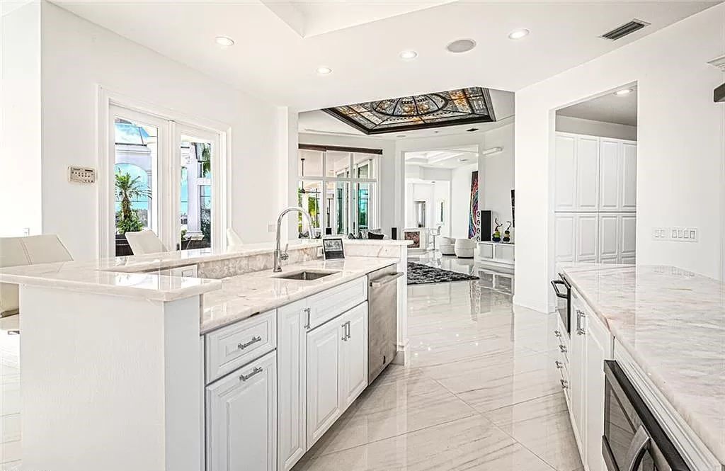 Welcome to Sunspray Estate, an exquisite 5-bedroom masterpiece nestled along the shores of a secluded spring-fed lake in Naples, Florida.