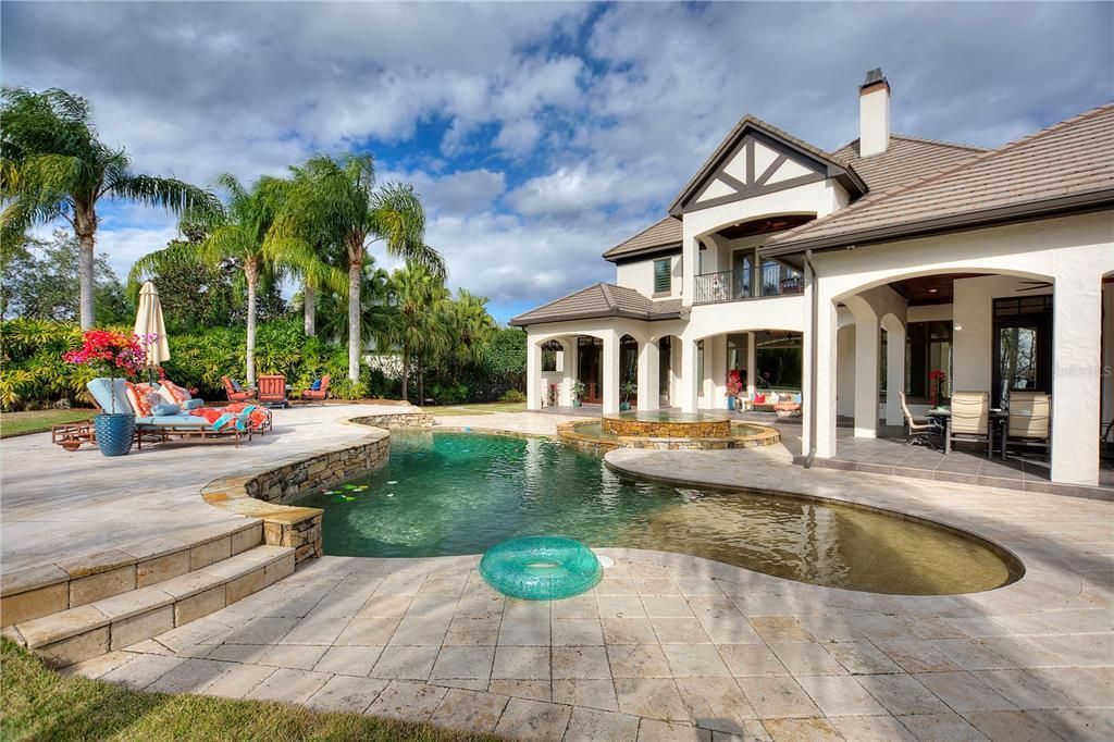 Named "Millionaires Cove," this Tudor Tuscan marvel blends Balinese and Indian influences. The gated community, housing only 29 residences, with 10 enjoying private lake access, ensures exclusive serenity.