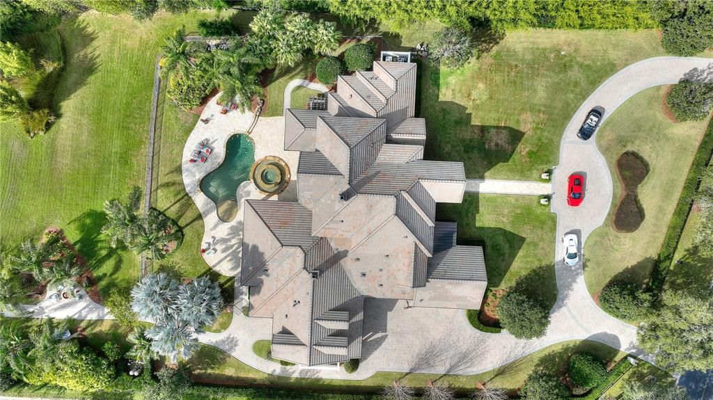 Named "Millionaires Cove," this Tudor Tuscan marvel blends Balinese and Indian influences. The gated community, housing only 29 residences, with 10 enjoying private lake access, ensures exclusive serenity.