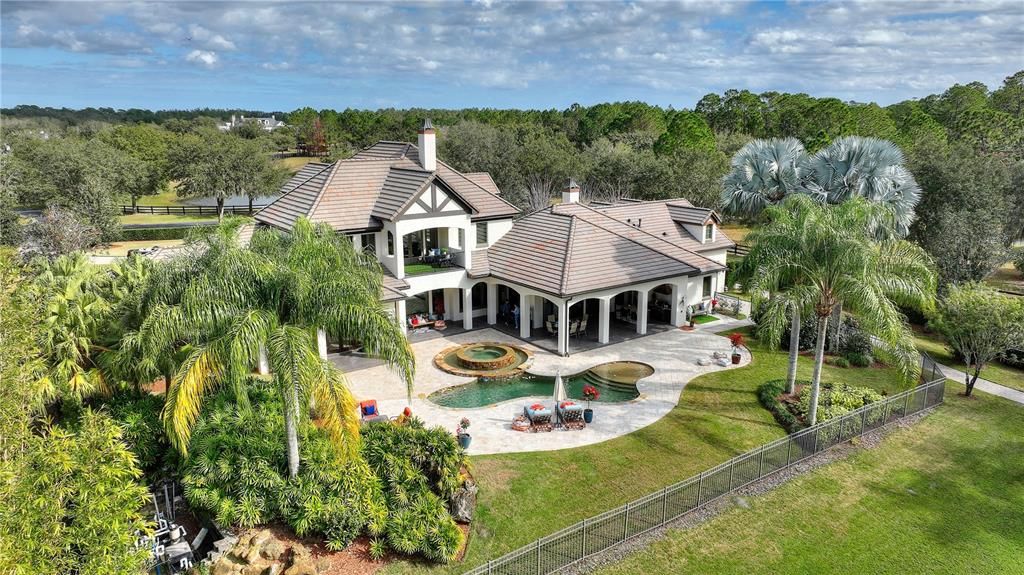 Named "Millionaires Cove," this Tudor Tuscan marvel blends Balinese and Indian influences. The gated community, housing only 29 residences, with 10 enjoying private lake access, ensures exclusive serenity.