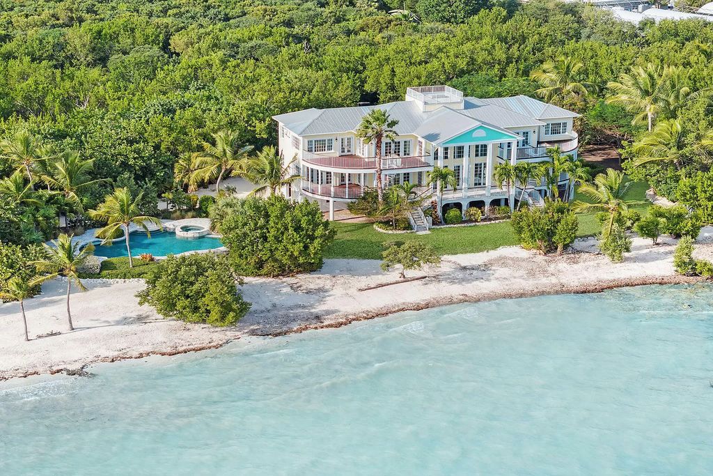 Experience the epitome of luxury island living at this exquisite Luxury Oceanfront Estate in Islamorada. Nestled on 10.85 acres along the Atlantic Ocean, this 2006-built property offers 450 feet of pristine beachfront accessed through a private, gated entrance.