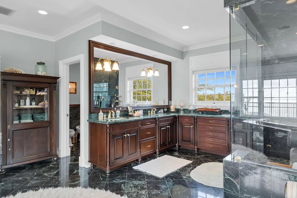 Experience the epitome of luxury island living at this exquisite Luxury Oceanfront Estate in Islamorada. Nestled on 10.85 acres along the Atlantic Ocean, this 2006-built property offers 450 feet of pristine beachfront accessed through a private, gated entrance.