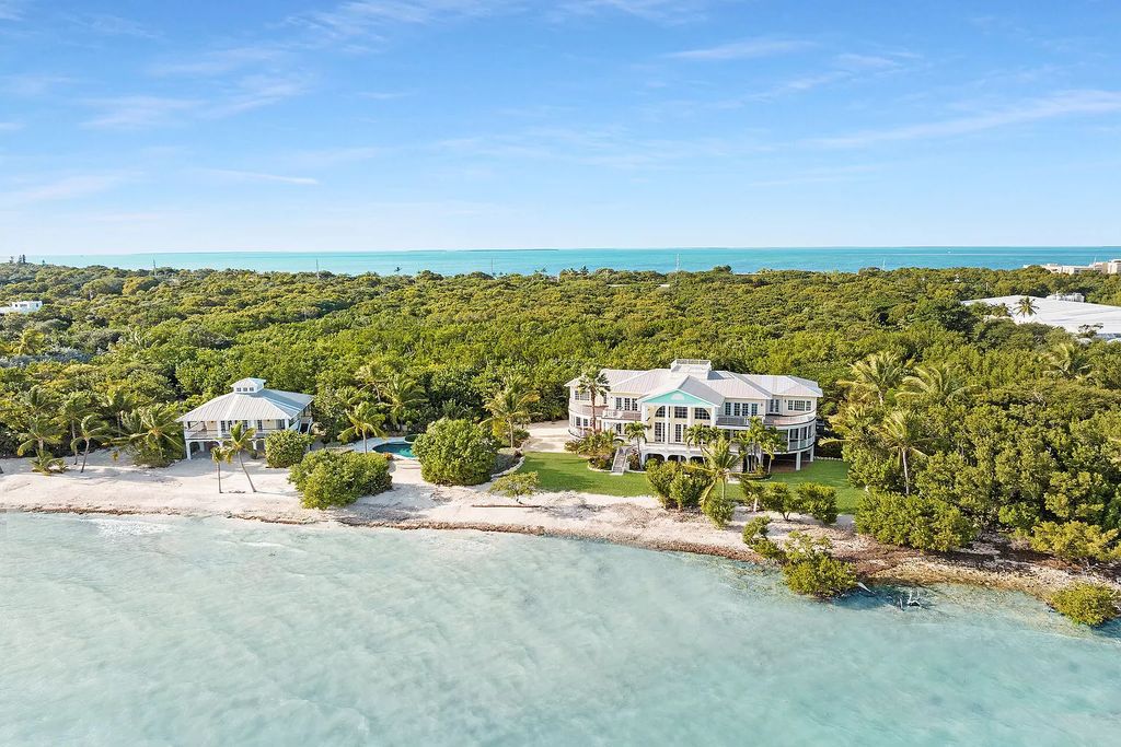 Experience the epitome of luxury island living at this exquisite Luxury Oceanfront Estate in Islamorada. Nestled on 10.85 acres along the Atlantic Ocean, this 2006-built property offers 450 feet of pristine beachfront accessed through a private, gated entrance.