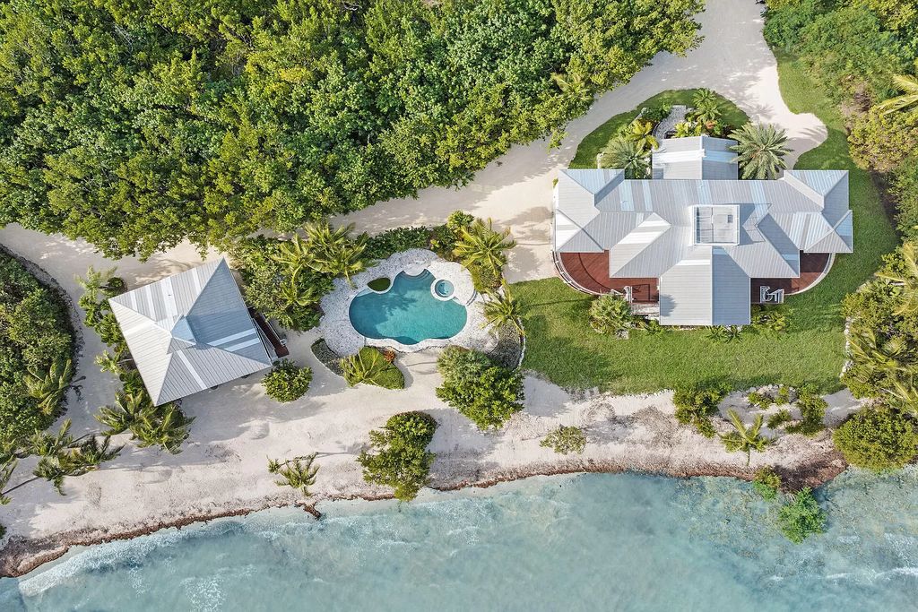 Experience the epitome of luxury island living at this exquisite Luxury Oceanfront Estate in Islamorada. Nestled on 10.85 acres along the Atlantic Ocean, this 2006-built property offers 450 feet of pristine beachfront accessed through a private, gated entrance.