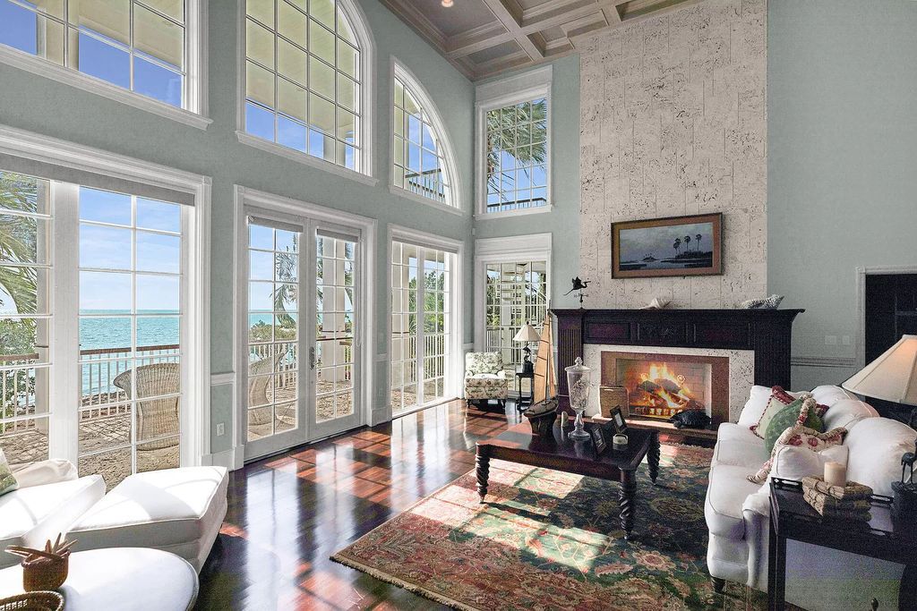 Experience the epitome of luxury island living at this exquisite Luxury Oceanfront Estate in Islamorada. Nestled on 10.85 acres along the Atlantic Ocean, this 2006-built property offers 450 feet of pristine beachfront accessed through a private, gated entrance.