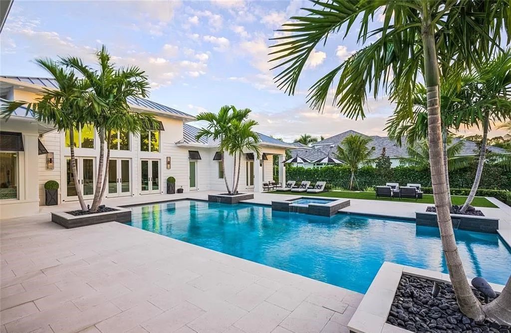 This sprawling 7,200 square feet single-story masterpiece in Pine Ridge epitomizes luxury living. With 6 bedrooms, a den, and a 6-car garage on a 1.31-acre lot, it boasts a wood-paneled library, a soaring two-story living room, and a gourmet kitchen with Wolf and Sub-Zero appliances.