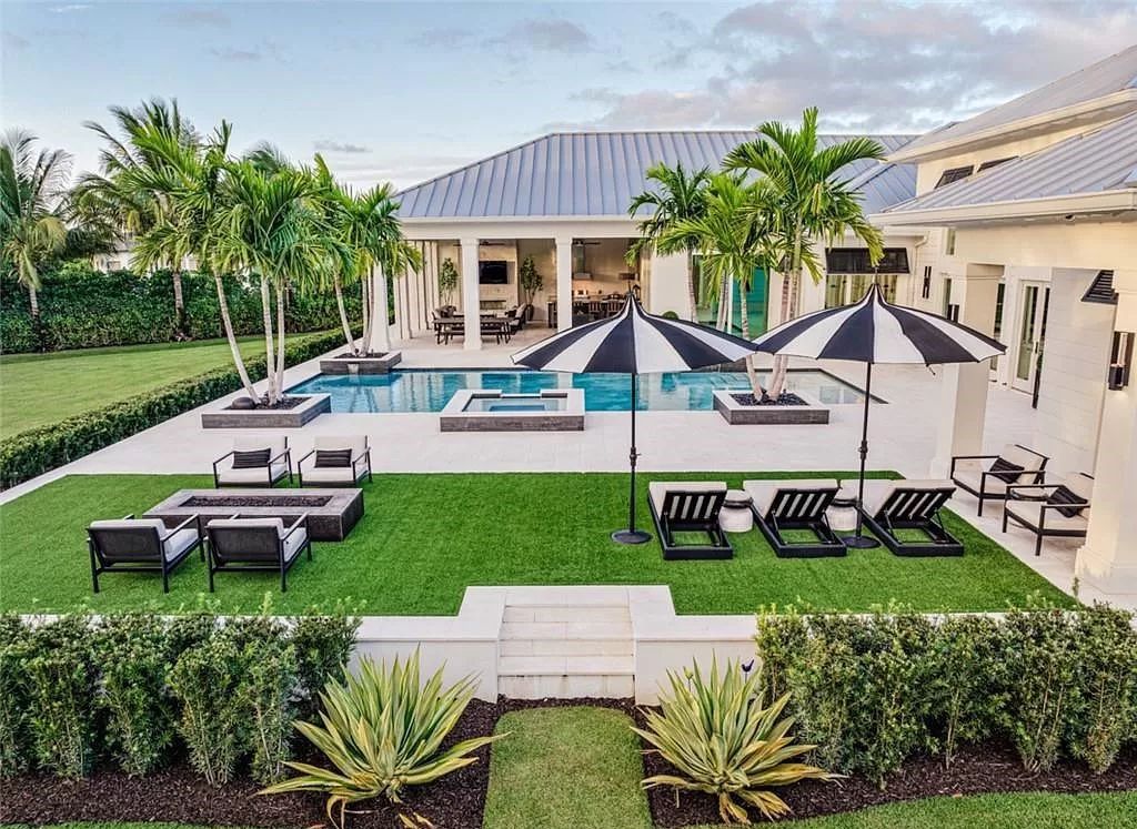 This sprawling 7,200 square feet single-story masterpiece in Pine Ridge epitomizes luxury living. With 6 bedrooms, a den, and a 6-car garage on a 1.31-acre lot, it boasts a wood-paneled library, a soaring two-story living room, and a gourmet kitchen with Wolf and Sub-Zero appliances.