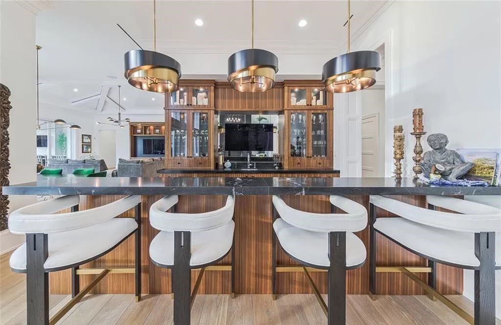 This sprawling 7,200 square feet single-story masterpiece in Pine Ridge epitomizes luxury living. With 6 bedrooms, a den, and a 6-car garage on a 1.31-acre lot, it boasts a wood-paneled library, a soaring two-story living room, and a gourmet kitchen with Wolf and Sub-Zero appliances.