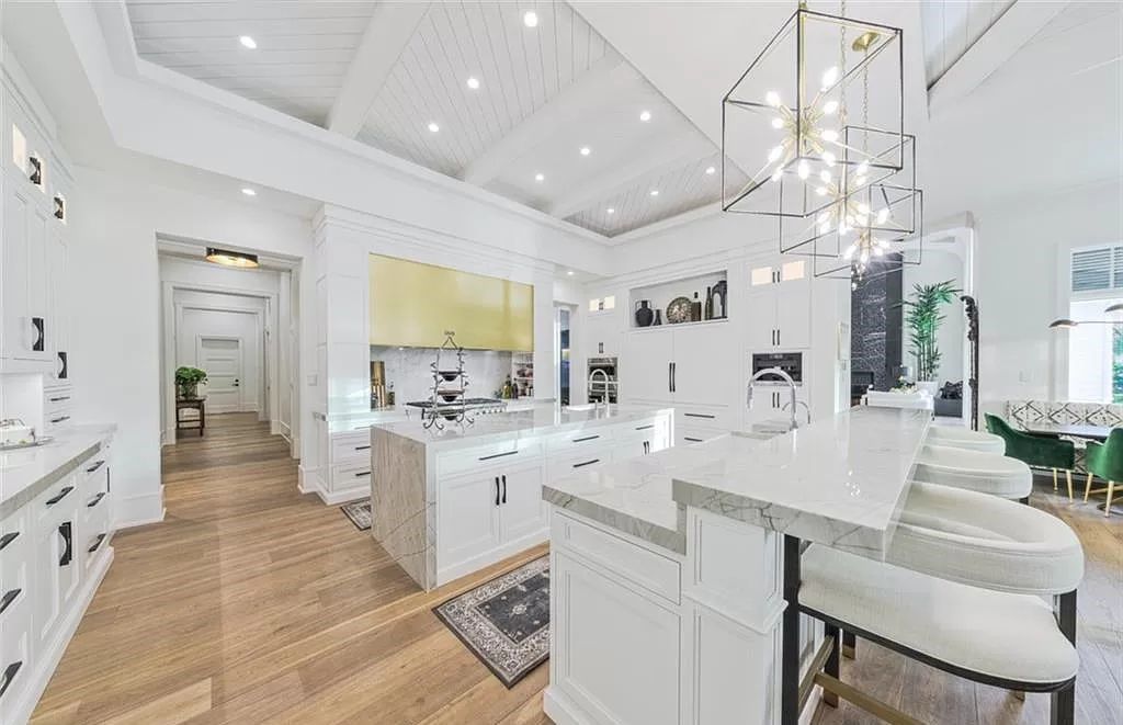 This sprawling 7,200 square feet single-story masterpiece in Pine Ridge epitomizes luxury living. With 6 bedrooms, a den, and a 6-car garage on a 1.31-acre lot, it boasts a wood-paneled library, a soaring two-story living room, and a gourmet kitchen with Wolf and Sub-Zero appliances.
