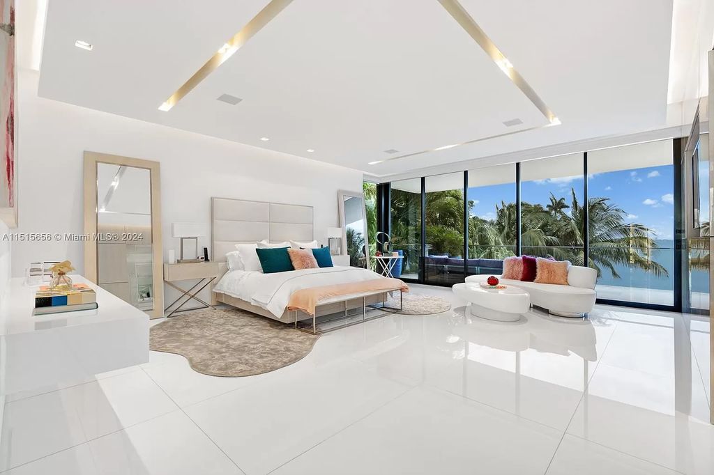 Welcome to 5004 N Bay Rd, a 2016 masterpiece by renowned designer Jennifer Post, blending modern architecture with timeless elegance. This 8-bed, 9-bath waterfront haven on prestigious North Bay Road boasts a stunning atrium courtyard, seamless living spaces, and a gourmet kitchen.