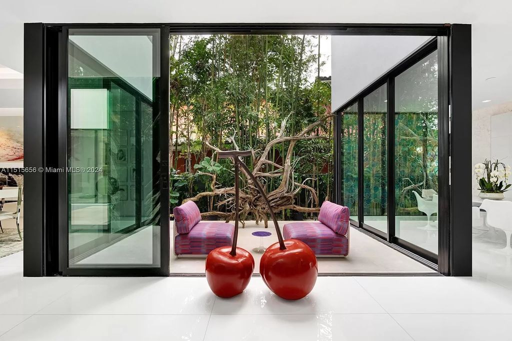 Welcome to 5004 N Bay Rd, a 2016 masterpiece by renowned designer Jennifer Post, blending modern architecture with timeless elegance. This 8-bed, 9-bath waterfront haven on prestigious North Bay Road boasts a stunning atrium courtyard, seamless living spaces, and a gourmet kitchen.