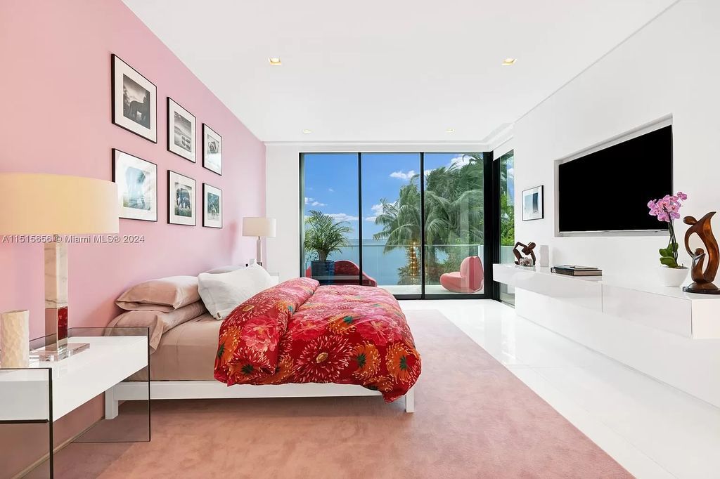 Welcome to 5004 N Bay Rd, a 2016 masterpiece by renowned designer Jennifer Post, blending modern architecture with timeless elegance. This 8-bed, 9-bath waterfront haven on prestigious North Bay Road boasts a stunning atrium courtyard, seamless living spaces, and a gourmet kitchen.