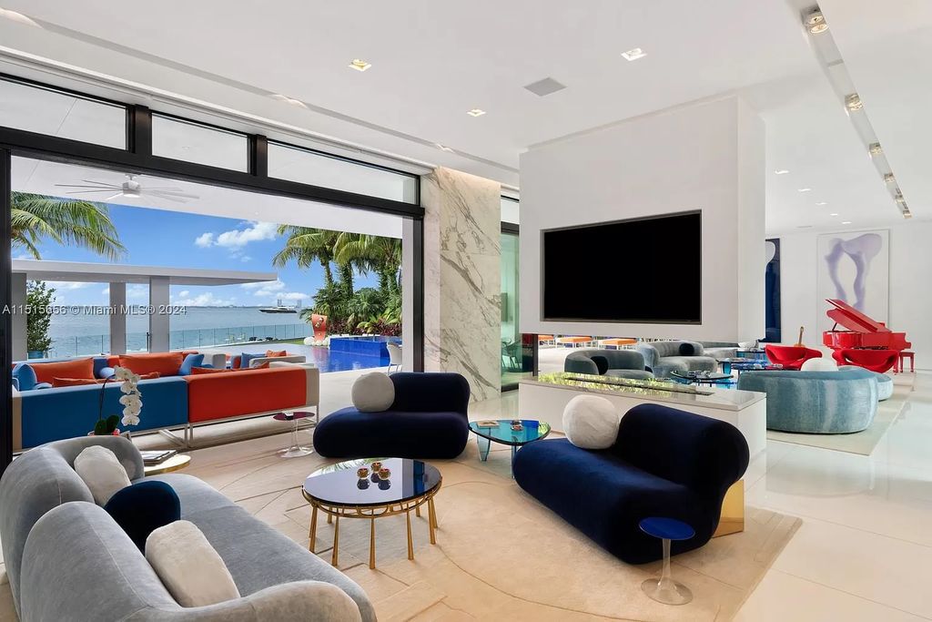 Welcome to 5004 N Bay Rd, a 2016 masterpiece by renowned designer Jennifer Post, blending modern architecture with timeless elegance. This 8-bed, 9-bath waterfront haven on prestigious North Bay Road boasts a stunning atrium courtyard, seamless living spaces, and a gourmet kitchen.