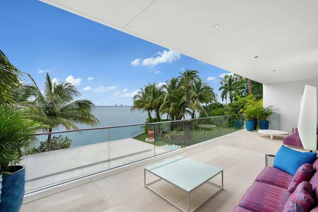 Welcome to 5004 N Bay Rd, a 2016 masterpiece by renowned designer Jennifer Post, blending modern architecture with timeless elegance. This 8-bed, 9-bath waterfront haven on prestigious North Bay Road boasts a stunning atrium courtyard, seamless living spaces, and a gourmet kitchen.