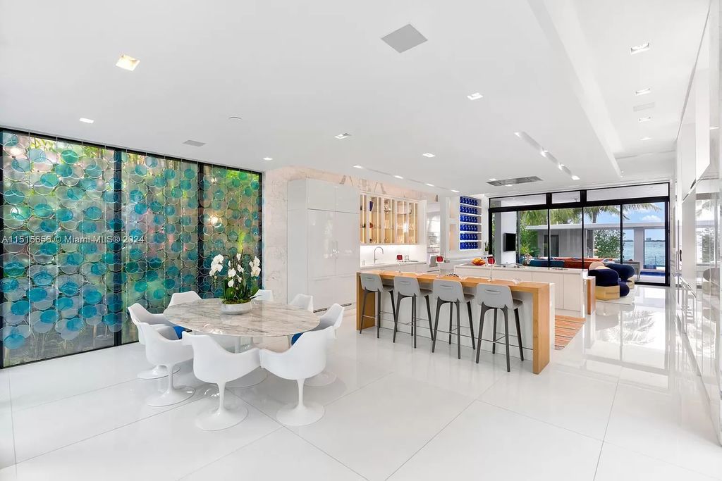 Welcome to 5004 N Bay Rd, a 2016 masterpiece by renowned designer Jennifer Post, blending modern architecture with timeless elegance. This 8-bed, 9-bath waterfront haven on prestigious North Bay Road boasts a stunning atrium courtyard, seamless living spaces, and a gourmet kitchen.
