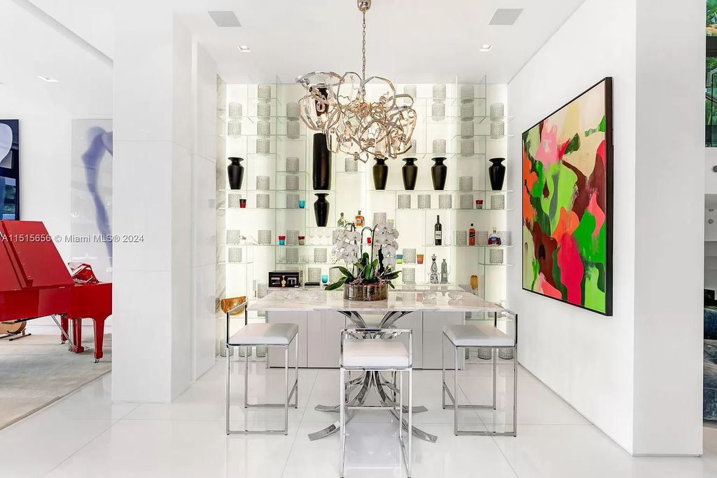 Welcome to 5004 N Bay Rd, a 2016 masterpiece by renowned designer Jennifer Post, blending modern architecture with timeless elegance. This 8-bed, 9-bath waterfront haven on prestigious North Bay Road boasts a stunning atrium courtyard, seamless living spaces, and a gourmet kitchen.