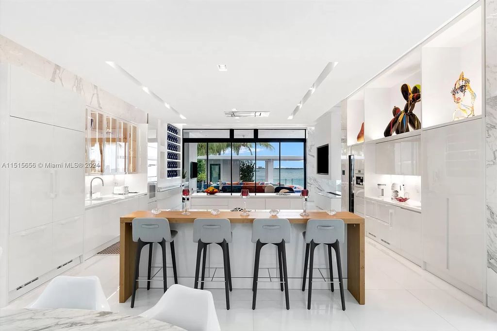 Welcome to 5004 N Bay Rd, a 2016 masterpiece by renowned designer Jennifer Post, blending modern architecture with timeless elegance. This 8-bed, 9-bath waterfront haven on prestigious North Bay Road boasts a stunning atrium courtyard, seamless living spaces, and a gourmet kitchen.