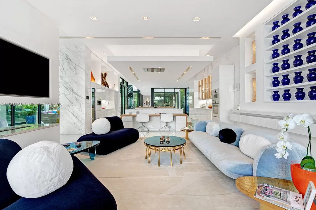 Welcome to 5004 N Bay Rd, a 2016 masterpiece by renowned designer Jennifer Post, blending modern architecture with timeless elegance. This 8-bed, 9-bath waterfront haven on prestigious North Bay Road boasts a stunning atrium courtyard, seamless living spaces, and a gourmet kitchen.