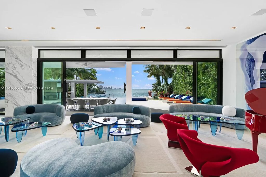 Welcome to 5004 N Bay Rd, a 2016 masterpiece by renowned designer Jennifer Post, blending modern architecture with timeless elegance. This 8-bed, 9-bath waterfront haven on prestigious North Bay Road boasts a stunning atrium courtyard, seamless living spaces, and a gourmet kitchen.