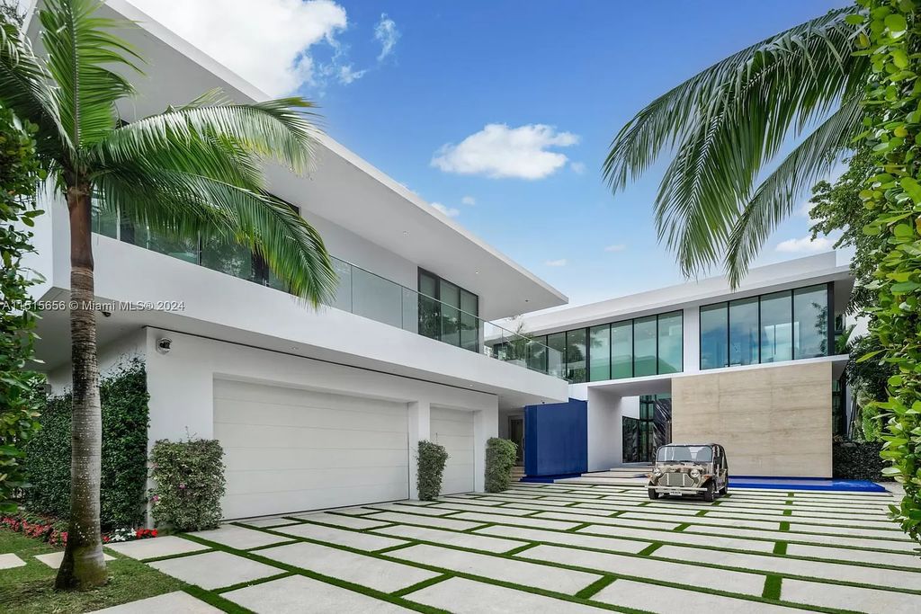 Welcome to 5004 N Bay Rd, a 2016 masterpiece by renowned designer Jennifer Post, blending modern architecture with timeless elegance. This 8-bed, 9-bath waterfront haven on prestigious North Bay Road boasts a stunning atrium courtyard, seamless living spaces, and a gourmet kitchen.