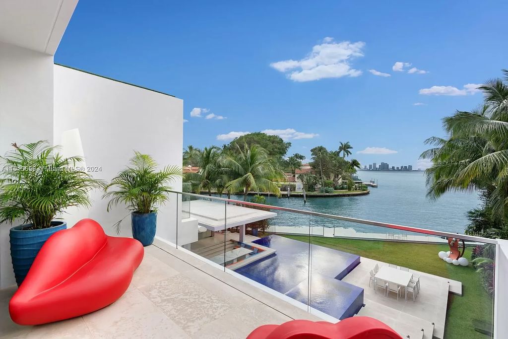Welcome to 5004 N Bay Rd, a 2016 masterpiece by renowned designer Jennifer Post, blending modern architecture with timeless elegance. This 8-bed, 9-bath waterfront haven on prestigious North Bay Road boasts a stunning atrium courtyard, seamless living spaces, and a gourmet kitchen.