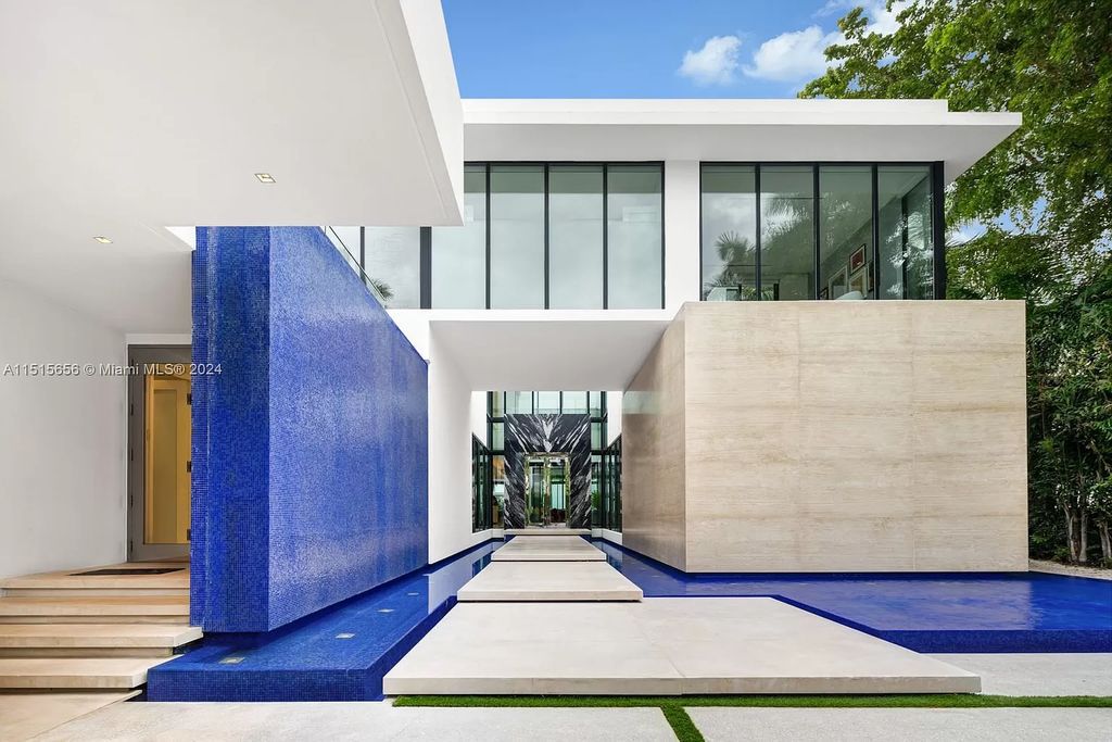 Welcome to 5004 N Bay Rd, a 2016 masterpiece by renowned designer Jennifer Post, blending modern architecture with timeless elegance. This 8-bed, 9-bath waterfront haven on prestigious North Bay Road boasts a stunning atrium courtyard, seamless living spaces, and a gourmet kitchen.