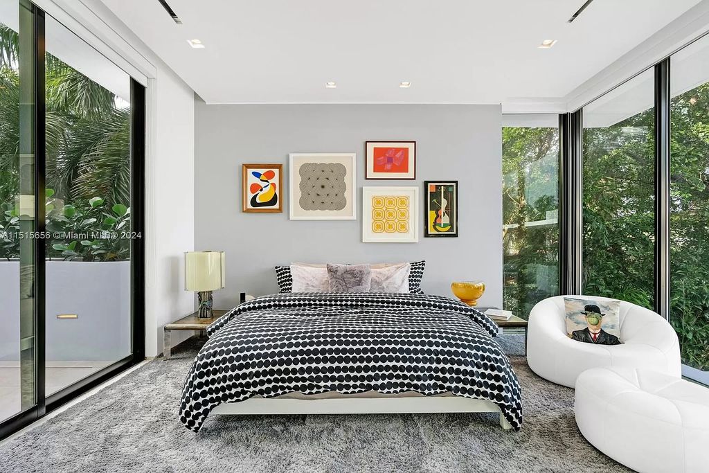 Welcome to 5004 N Bay Rd, a 2016 masterpiece by renowned designer Jennifer Post, blending modern architecture with timeless elegance. This 8-bed, 9-bath waterfront haven on prestigious North Bay Road boasts a stunning atrium courtyard, seamless living spaces, and a gourmet kitchen.