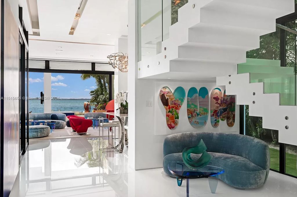 Welcome to 5004 N Bay Rd, a 2016 masterpiece by renowned designer Jennifer Post, blending modern architecture with timeless elegance. This 8-bed, 9-bath waterfront haven on prestigious North Bay Road boasts a stunning atrium courtyard, seamless living spaces, and a gourmet kitchen.