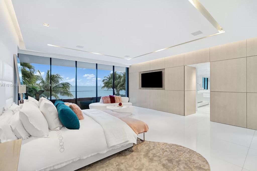 Welcome to 5004 N Bay Rd, a 2016 masterpiece by renowned designer Jennifer Post, blending modern architecture with timeless elegance. This 8-bed, 9-bath waterfront haven on prestigious North Bay Road boasts a stunning atrium courtyard, seamless living spaces, and a gourmet kitchen.