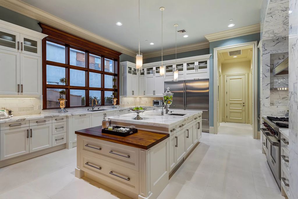 Crafted by Frankel Estate Homes, designed by Carlos Martin Architects, and styled by Marc-Michaels, this 6-bedroom, 10-bathroom mansion showcases an elegant staircase, grand salon, modern kitchen, and a lavish primary suite with waterfront vistas.