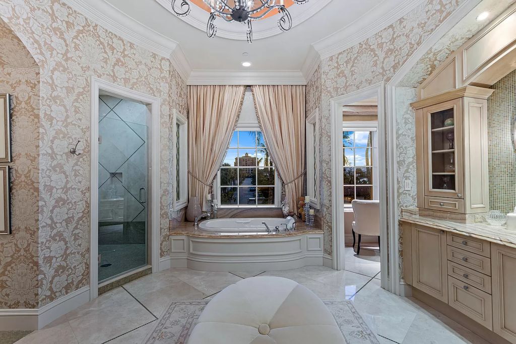 Crafted by Frankel Estate Homes, designed by Carlos Martin Architects, and styled by Marc-Michaels, this 6-bedroom, 10-bathroom mansion showcases an elegant staircase, grand salon, modern kitchen, and a lavish primary suite with waterfront vistas.