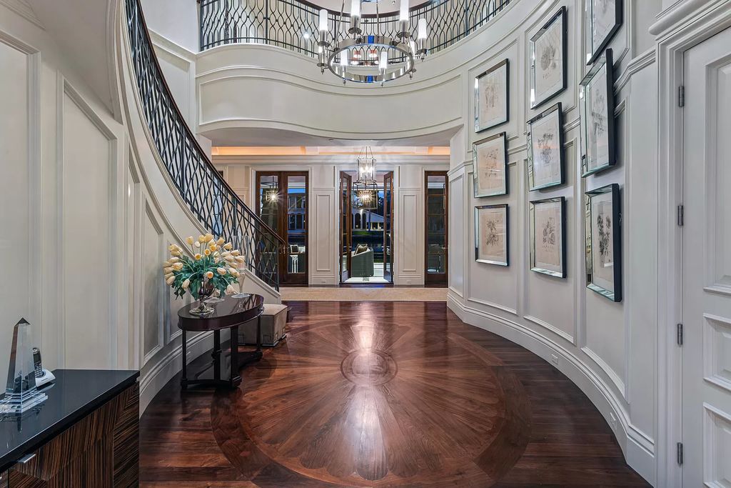 Crafted by Frankel Estate Homes, designed by Carlos Martin Architects, and styled by Marc-Michaels, this 6-bedroom, 10-bathroom mansion showcases an elegant staircase, grand salon, modern kitchen, and a lavish primary suite with waterfront vistas.