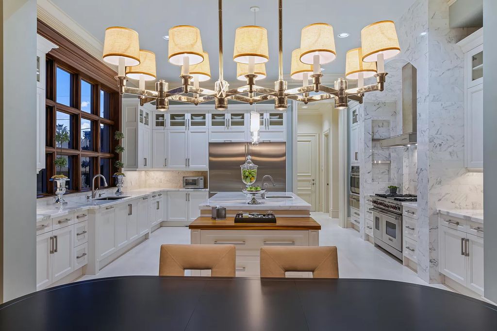 Crafted by Frankel Estate Homes, designed by Carlos Martin Architects, and styled by Marc-Michaels, this 6-bedroom, 10-bathroom mansion showcases an elegant staircase, grand salon, modern kitchen, and a lavish primary suite with waterfront vistas.