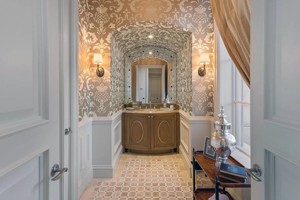 Crafted by Frankel Estate Homes, designed by Carlos Martin Architects, and styled by Marc-Michaels, this 6-bedroom, 10-bathroom mansion showcases an elegant staircase, grand salon, modern kitchen, and a lavish primary suite with waterfront vistas.