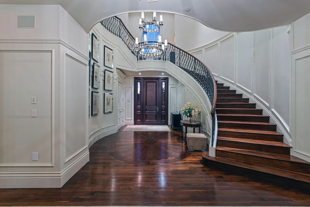 Crafted by Frankel Estate Homes, designed by Carlos Martin Architects, and styled by Marc-Michaels, this 6-bedroom, 10-bathroom mansion showcases an elegant staircase, grand salon, modern kitchen, and a lavish primary suite with waterfront vistas.
