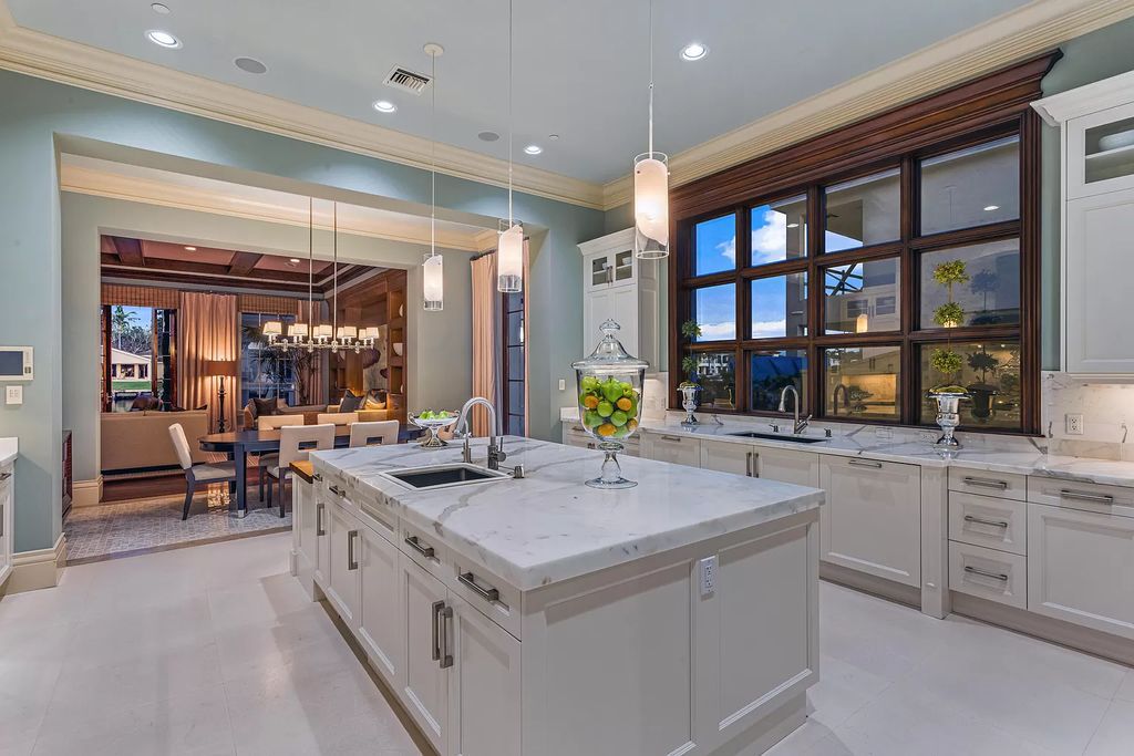 Crafted by Frankel Estate Homes, designed by Carlos Martin Architects, and styled by Marc-Michaels, this 6-bedroom, 10-bathroom mansion showcases an elegant staircase, grand salon, modern kitchen, and a lavish primary suite with waterfront vistas.